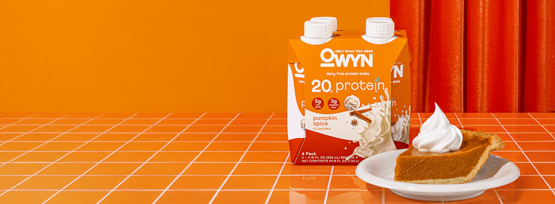 Owyn pumpkin spice flavored protein drink with pumpkin pie on a plate with orange color background